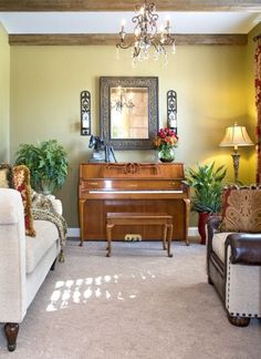 a living room filled with furniture and a piano