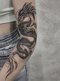 a woman with a dragon tattoo on her arm