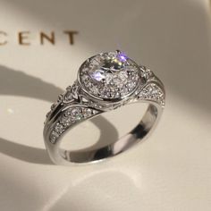 a diamond ring sitting on top of a white box