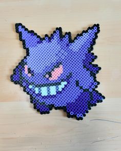 the pixel art is made out of plastic and has an image of a pokemon character on it