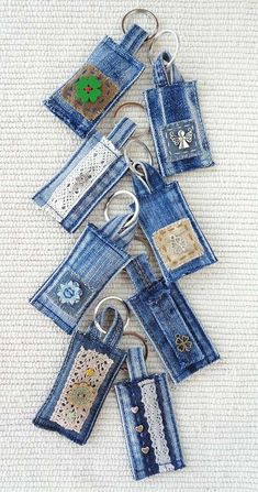 several pieces of blue jean fabric have been stitched together and are hanging on a keychain