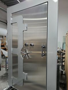 a large stainless steel refrigerator in a warehouse