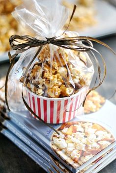 a bag of popcorn sitting on top of a table next to cookies and crackers