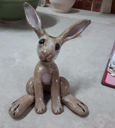 a ceramic rabbit sitting on top of a counter