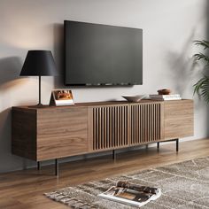 a living room with a large flat screen tv mounted on the wall and wooden furniture