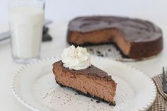 a slice of chocolate pie on a plate with a glass of milk next to it