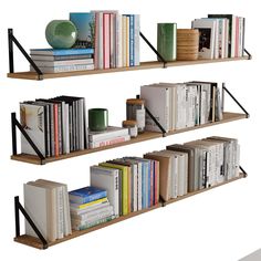 three bookshelves with various types of books on them and one has a green vase