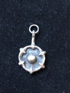 Sterling silver pendant with Tudor Rose design I cast these from a real ancient Tudor clothes fastener. 30mm high Ring for cord or chain. Supplied with FREE silk cord in blue / copper of black. Medieval Sterling Silver Pendant Jewelry, Medieval Silver Round Pendant Necklace, Antique Flower Charm Pendant Jewelry, Tudor Rose, Rose Necklace, Silk Cord, Jewelry Inspo, Rose Design, Sterling Silver Pendant