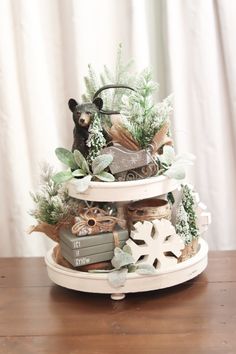 a three tiered cake with a bear and snowflakes on it