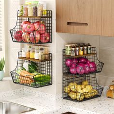 two metal baskets filled with food on top of a kitchen counter