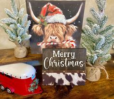 a christmas card with a cow wearing a santa hat