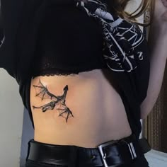 a woman with a tattoo on her stomach