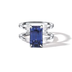 a blue sapphire and diamond ring on a white background