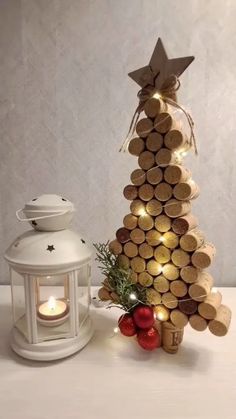 a small christmas tree made out of wine corks and lit up by a candle