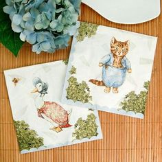 two placemats with cats and birds on them next to a blue hydrant