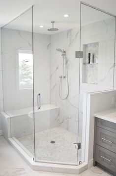 a walk in shower sitting inside of a bathroom