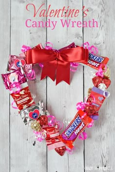 a valentine's candy wreath on a white wooden background with the words, valentines candy wreath