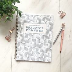 the practice planner is sitting on top of a marble table