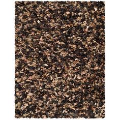 an area rug with various colors and textures on it, including black, brown, white and