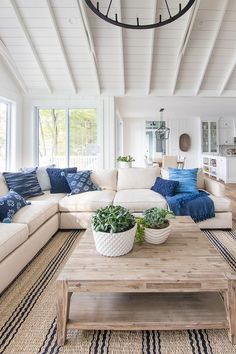 a living room filled with furniture and a large clock hanging from the ceiling above it