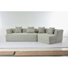 a large sectional couch sitting on top of a white floor