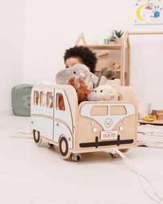 a child's toy bus with stuffed animals in it