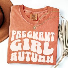 The perfect fall pregnancy shirt! COMFORT COLORS 1717 UNISEX SHIRT One of the most popular t-shirts on the market.  Extremely soft and 100% ring-spun cotton The fabric has been meticulously garment-dyed using the signature Comfort Colors process, resulting in rich, vibrant colors that are designed to fade gracefully over time, adding to the shirt's unique character and vintage appeal.  SIZING Tees are a UNISEX, relaxed fit. Please refer to the size chart in the listing photos for details. Easy measuring tip: Take your favorite tee, lay it on a flat surface, and measure the width (armpit to armpit) and the length (top to bottom) YOU HAVE TO SIZE UP (RECOMMENDED 2 SIZES) FOR OVERSIZED LOOK PROCESSING + SHIPPING Production time: 1-3 days Shipping: 2-5 days  All items are made to order. They w Maternity Cotton T-shirt With Letter Print, Fall Maternity Shirts, Fall Pregnancy Shirts, Cotton Maternity T-shirt With Crew Neck, Maternity Crew Neck T-shirt With Letter Print, Maternity Cotton T-shirt With Graphic Print, Cotton Maternity T-shirt With Short Sleeves, Cotton Crew Neck Maternity T-shirt, Maternity Wear Graphic Print Crew Neck T-shirt