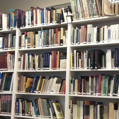 the bookshelves are full of many different colored books