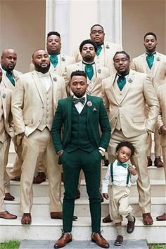 a group of men standing next to each other wearing suits and bow ties on steps