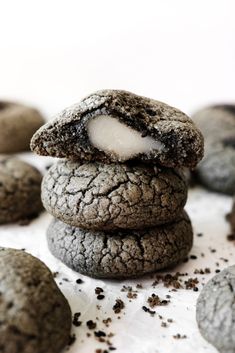 chocolate cookies are stacked on top of each other with marshmallows in the middle