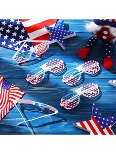 patriotic glasses and american flags on blue wood