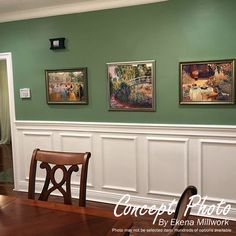 a dining room with green walls and paintings on the wall