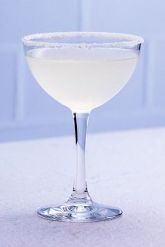 a glass filled with white liquid on top of a table