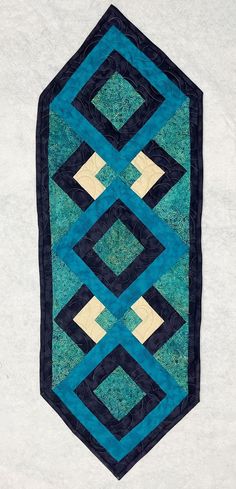 a blue and black quilted wall hanging