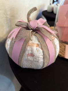 a pink and white pumpkin sitting on top of a table