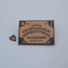 a small wooden sign with the letters and numbers on it