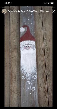 an image of santa clause painted on wood planks