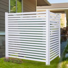 a white privacy screen in front of a house