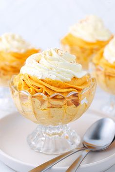 some desserts are sitting on a plate with silverware