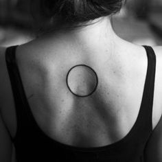 a woman with a circle tattoo on her back