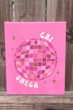 a pink canvas with the words cm and an image of a disco ball on it