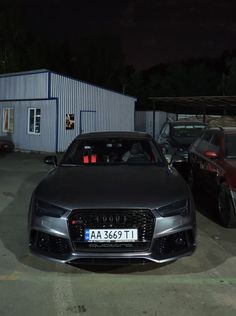 two cars parked next to each other in a parking lot