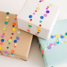 three wrapped presents with confetti on them