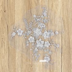 a bouquet of flowers on a wooden surface with clear plastic overlaying the image