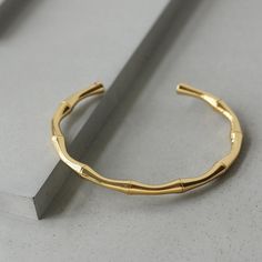 This bracelet is lightweight and easy to wear, and lend a modern edge to your jewelry wardrobe. It goes well with our BAMBOO EARRING. Material: 316L Stainless Steel, 18k Gold Plated Size: 6"-7.5" Origin: California, USA Each product packed with SOCALI premium pouch and box, together with silver cleaning cloth and card. Material Our products are made from the top-grade 316L stainless steel - a metal that is nickel-free and does not fade or blacken and 100% hypoallergenic for the benefit of those Minimalist Yellow Gold Metal Bangle, Modern Tarnish-resistant Gold Bangle Bracelet, Gold Hoop Bangle In Minimalist Style, Minimalist Gold Hoop Bangle, Minimalist Metal Bangle Tarnish Resistant, Modern Gold-plated Tarnish-resistant Bangle, Minimalist Hoop Bangle In Yellow Gold, Minimalist Yellow Gold Hoop Bangle, Minimalist Gold Plated Round Bangle