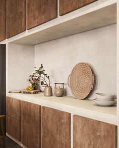 a kitchen with wooden cabinets and plates on the counter