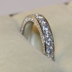 a close up view of a wedding ring with diamonds on the outside and inside it