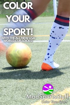 a person kicking a soccer ball on top of a grass field with the words, color your sport with the all new usa world cup socks