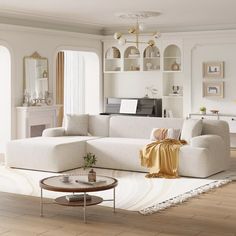 a living room filled with furniture and a white rug on top of a hard wood floor