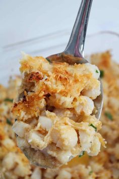 a spoon full of baked cheesy scallops